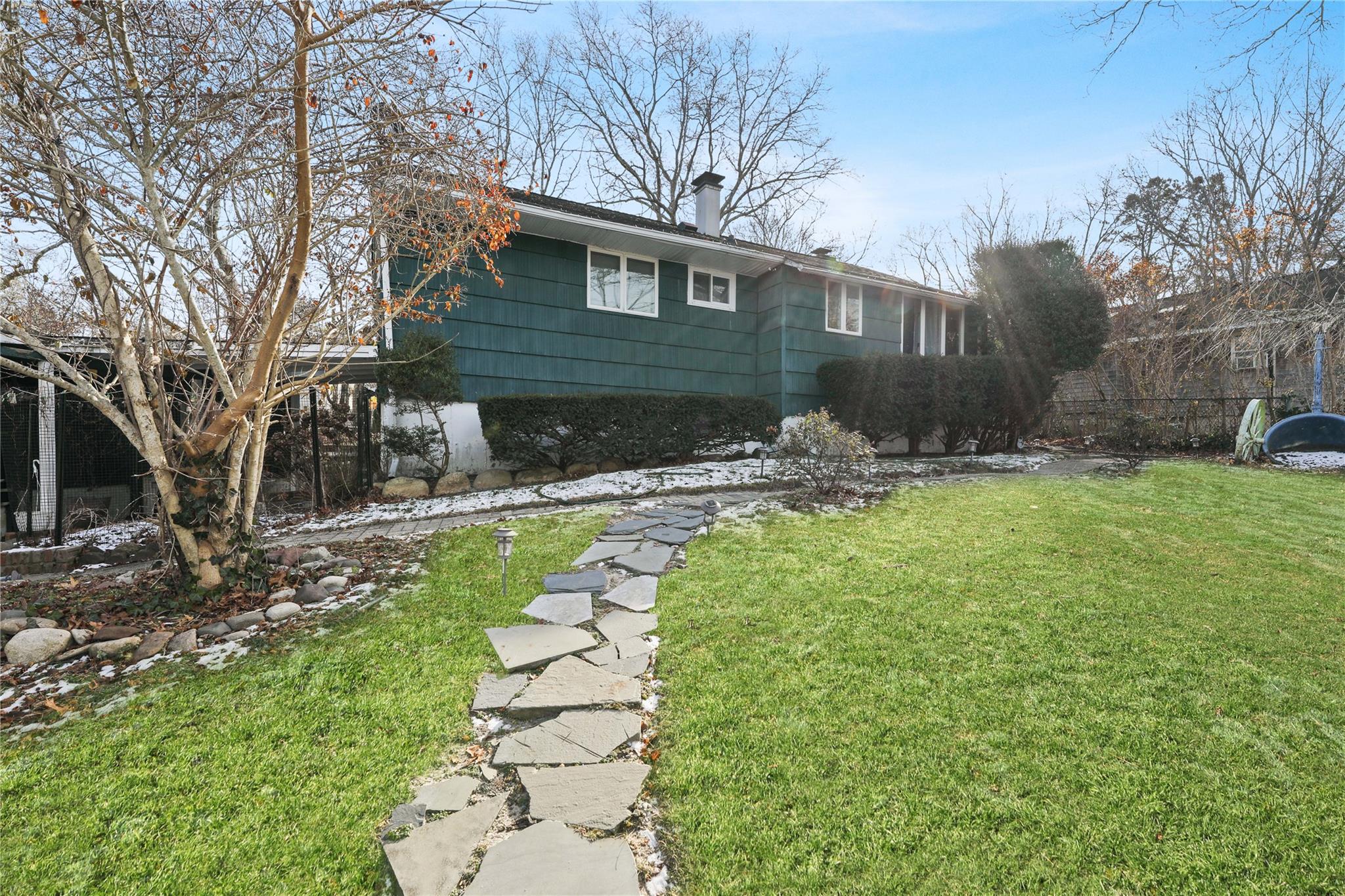 a front view of a house with garden and patio