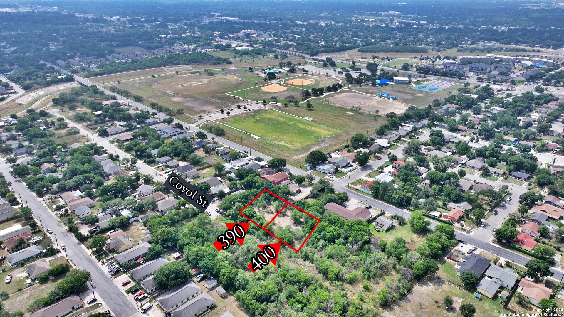 an aerial view of residential houses with outdoor space