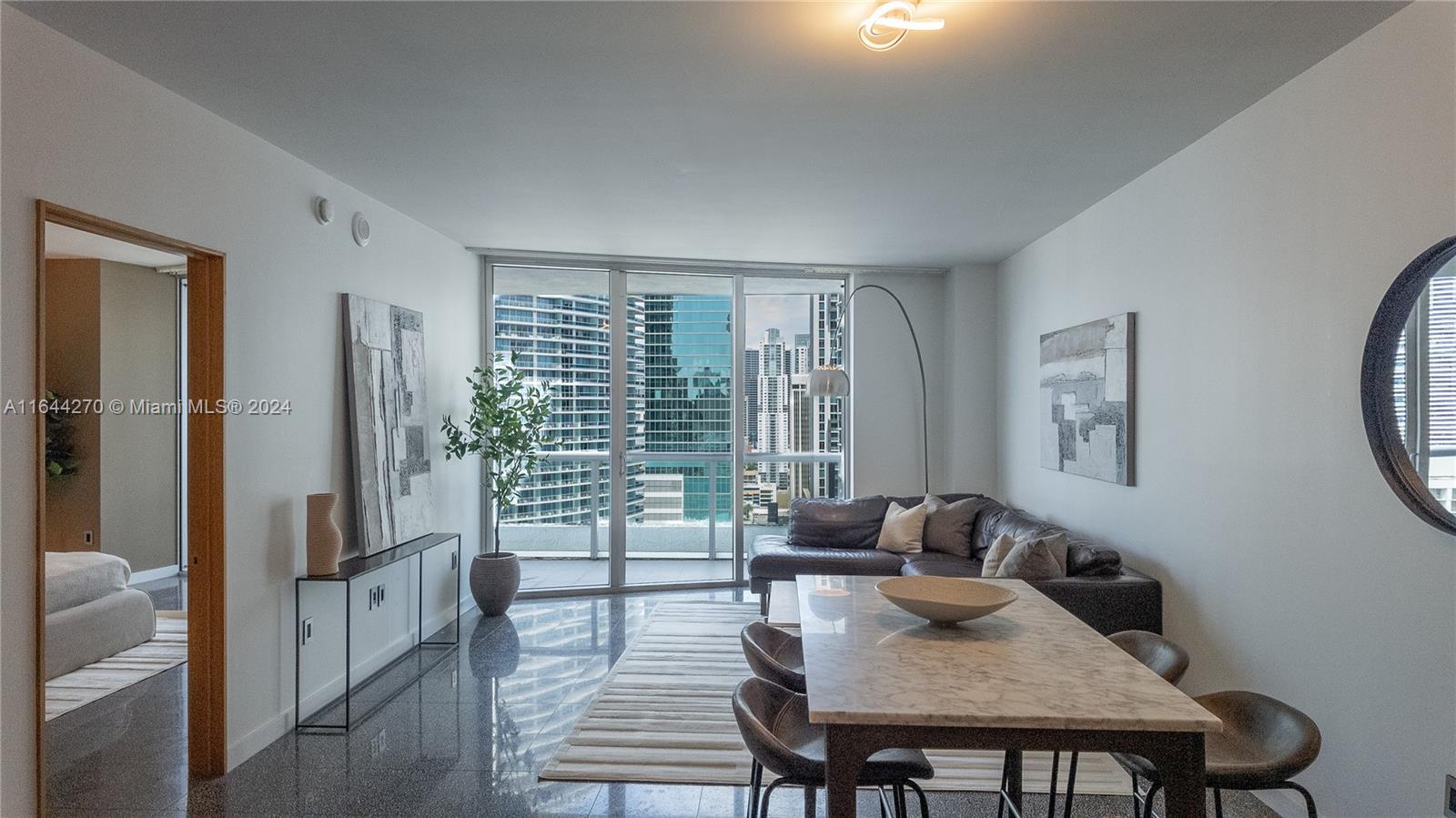 a living room with furniture and a floor to ceiling window