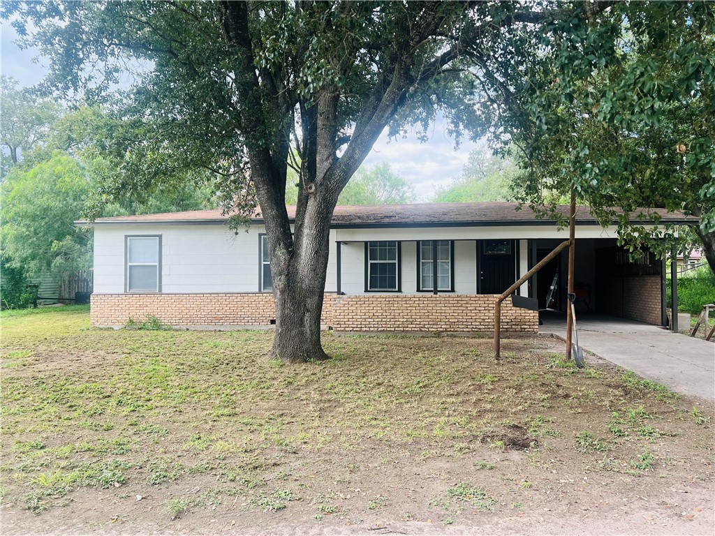 a house that has a tree in front of it