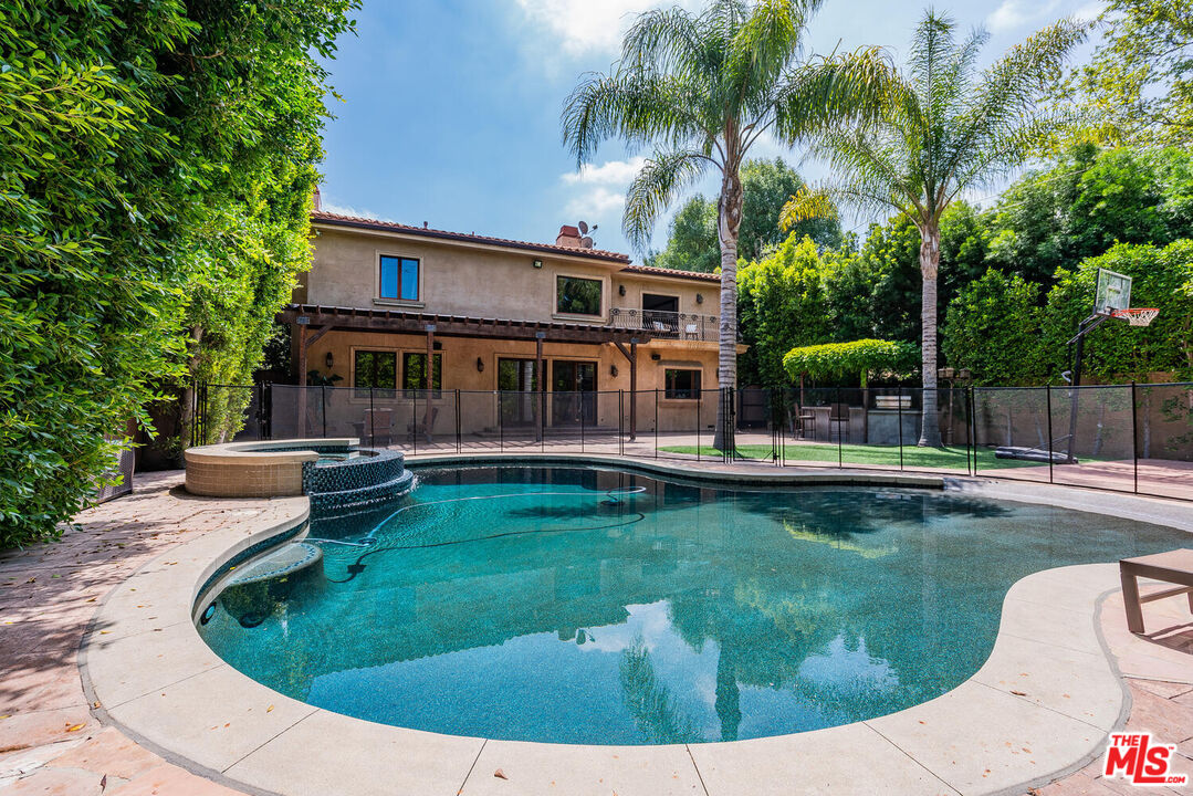 a view of a house with swimming pool and sitting area