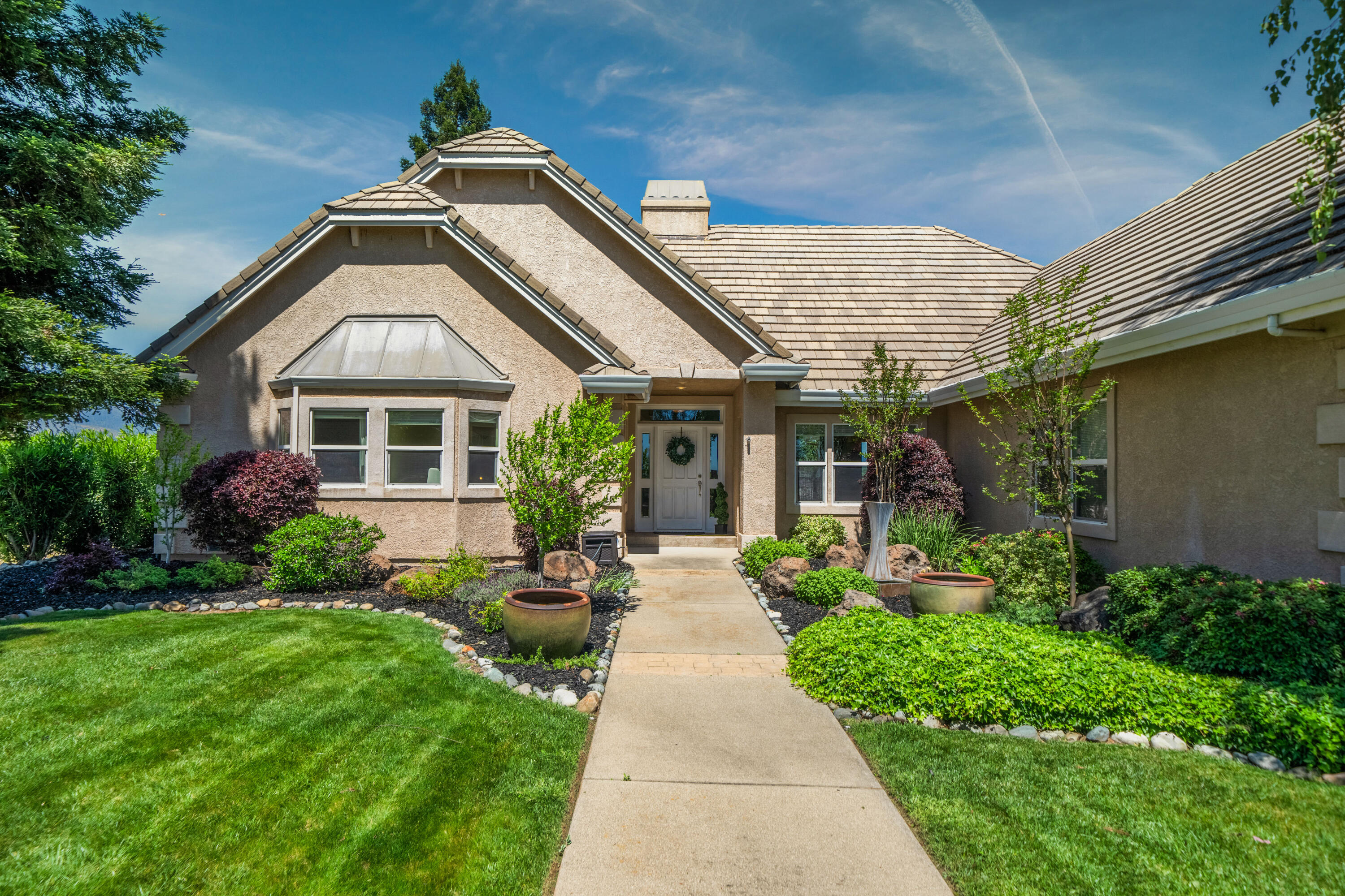 a front view of a house with garden