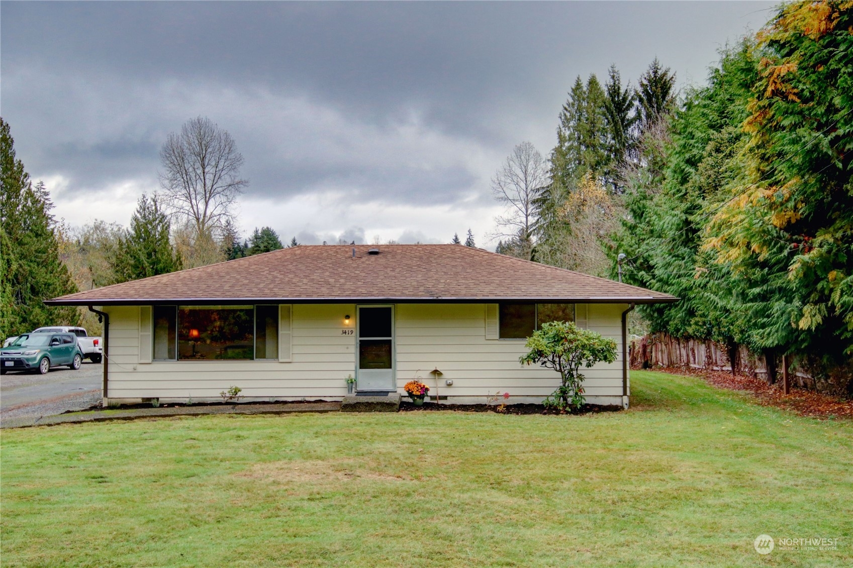 a front view of a house with a garden