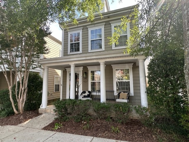 front view of a brick house with a small yard