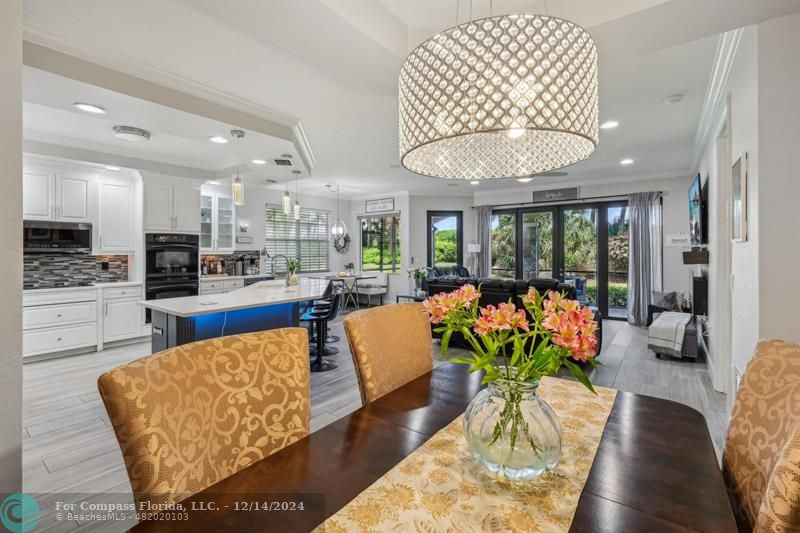 a living room filled with furniture and a chandelier