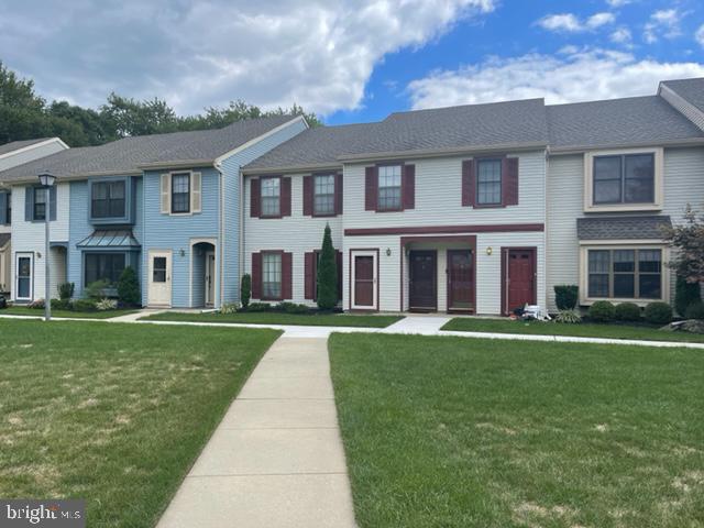 front view of a brick house with a yard