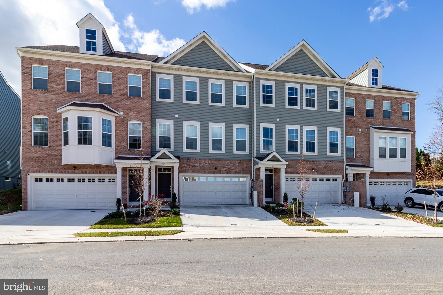 a front view of a residential apartment building with a yard