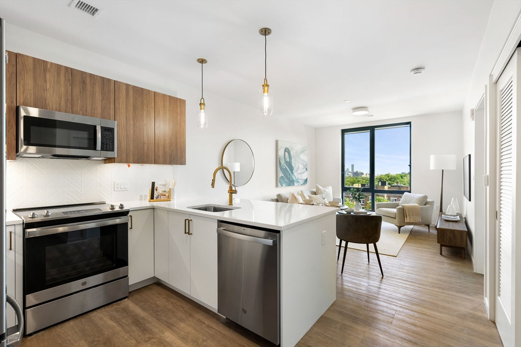 a kitchen with a stove a sink and a microwave