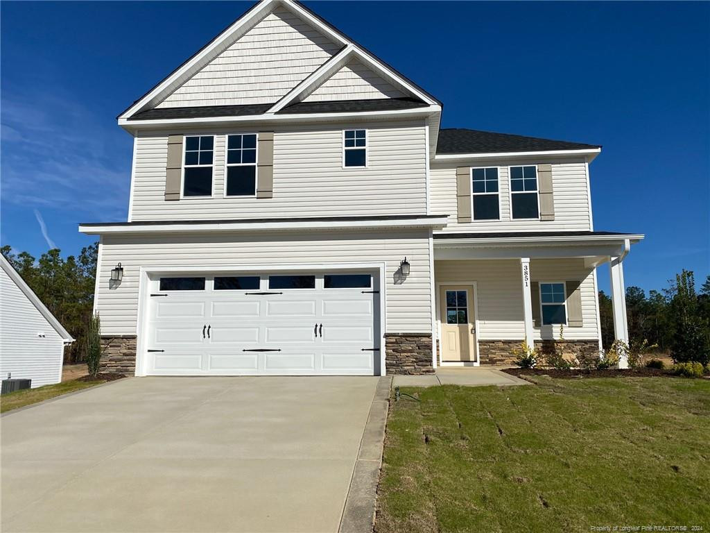 a front view of a house with a yard and garage