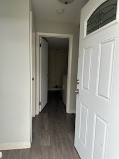 a view of a hallway with a wooden door