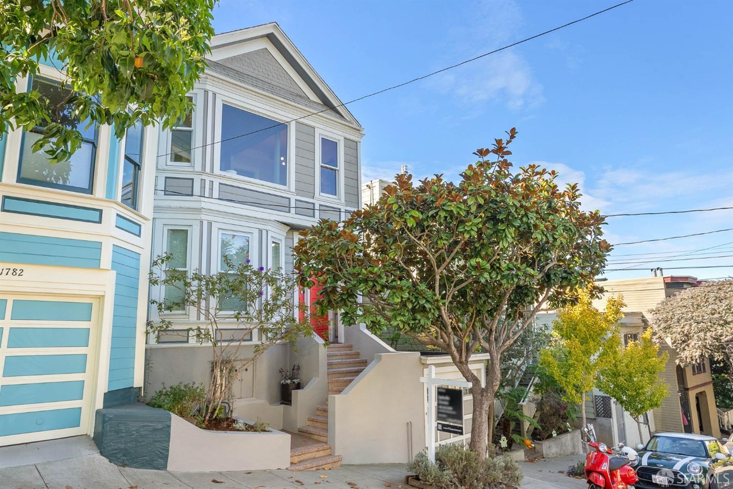 a front view of a house with plants