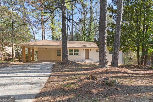 a view of a house with a trees in front of it