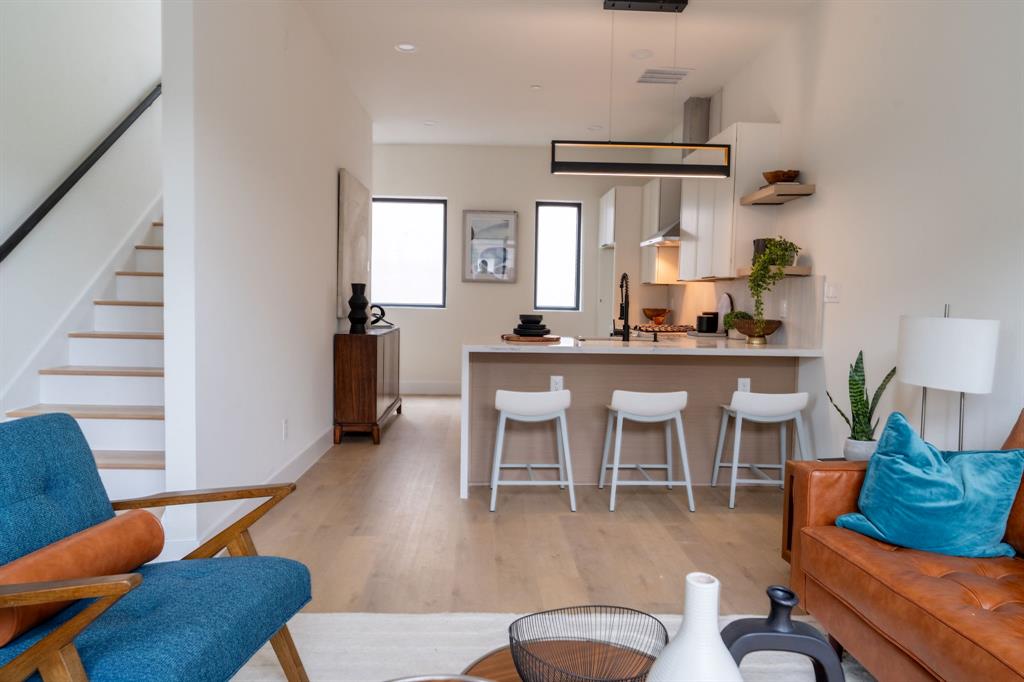 a dining room with furniture a rug and wooden floor