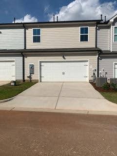 a front view of a house with garage