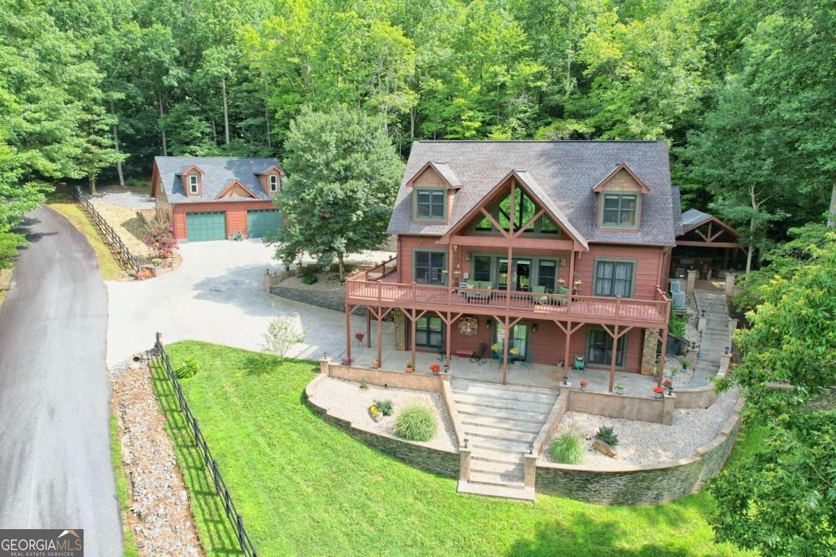 an aerial view of a house with swimming pool garden and patio