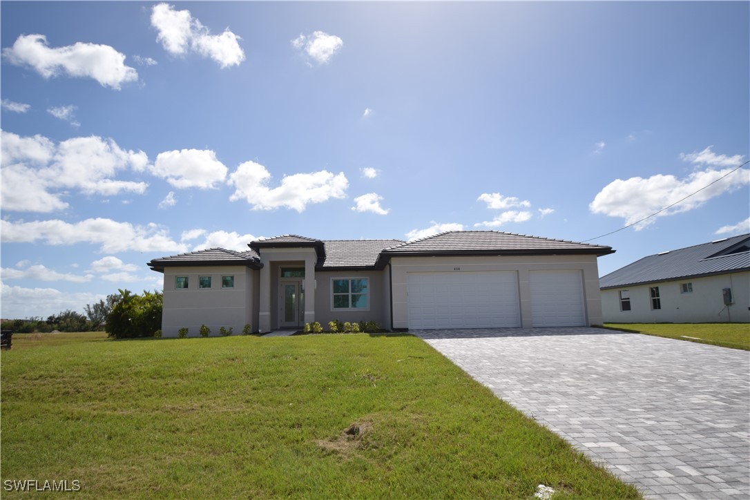 a front view of a house with a yard and garage