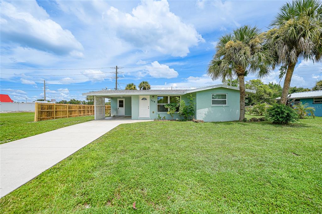 a front view of house with yard and green space