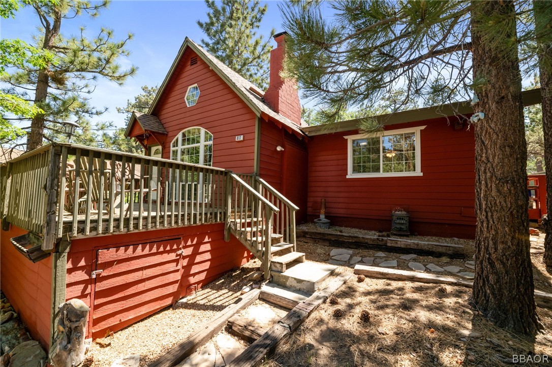 a view of a wooden house with a small yard