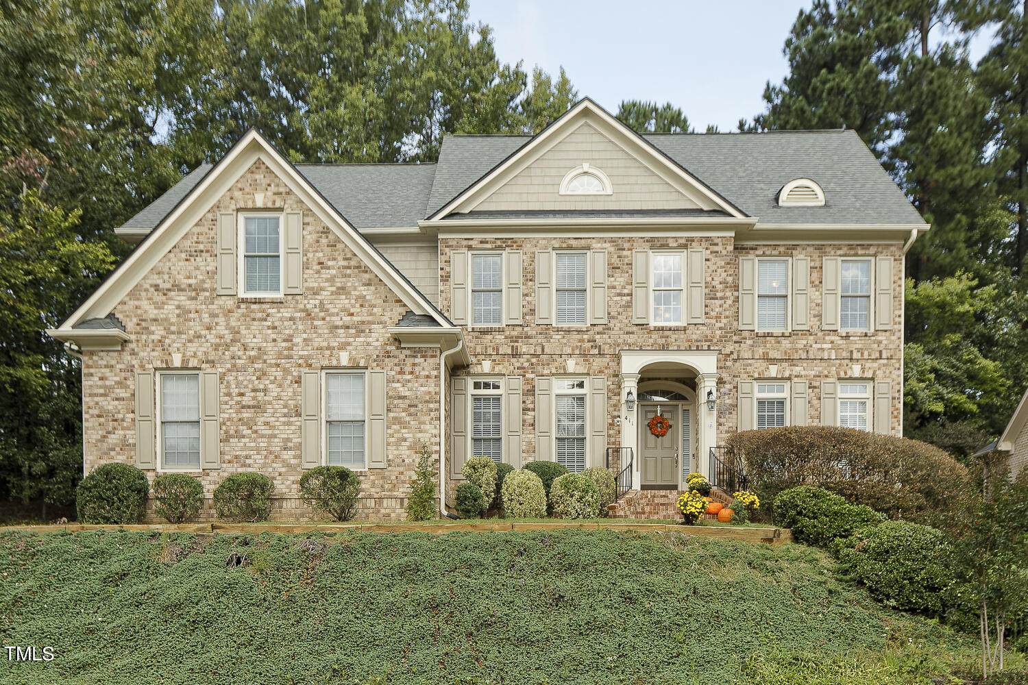 a front view of a house with a yard