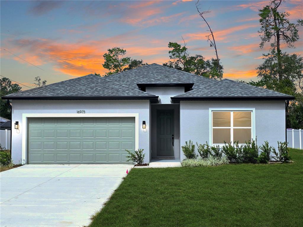 a front view of a house with a garden