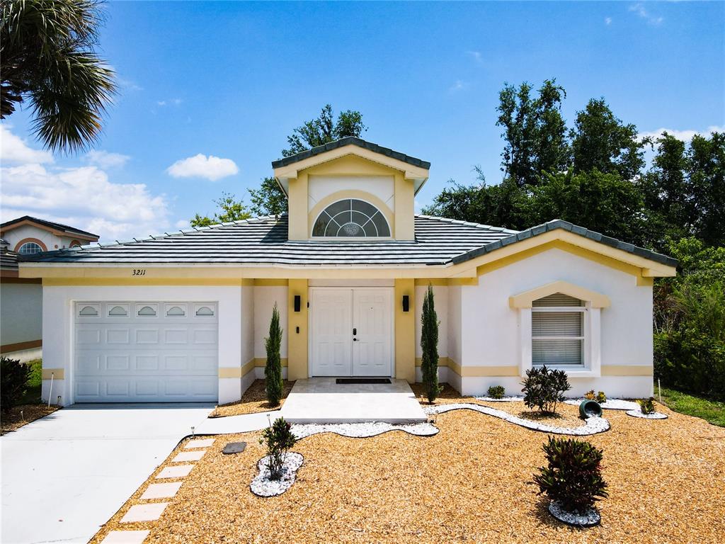 a front view of a house with garden