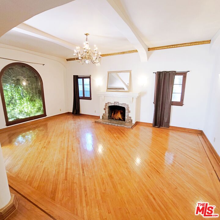 a view of empty room with fireplace and fan