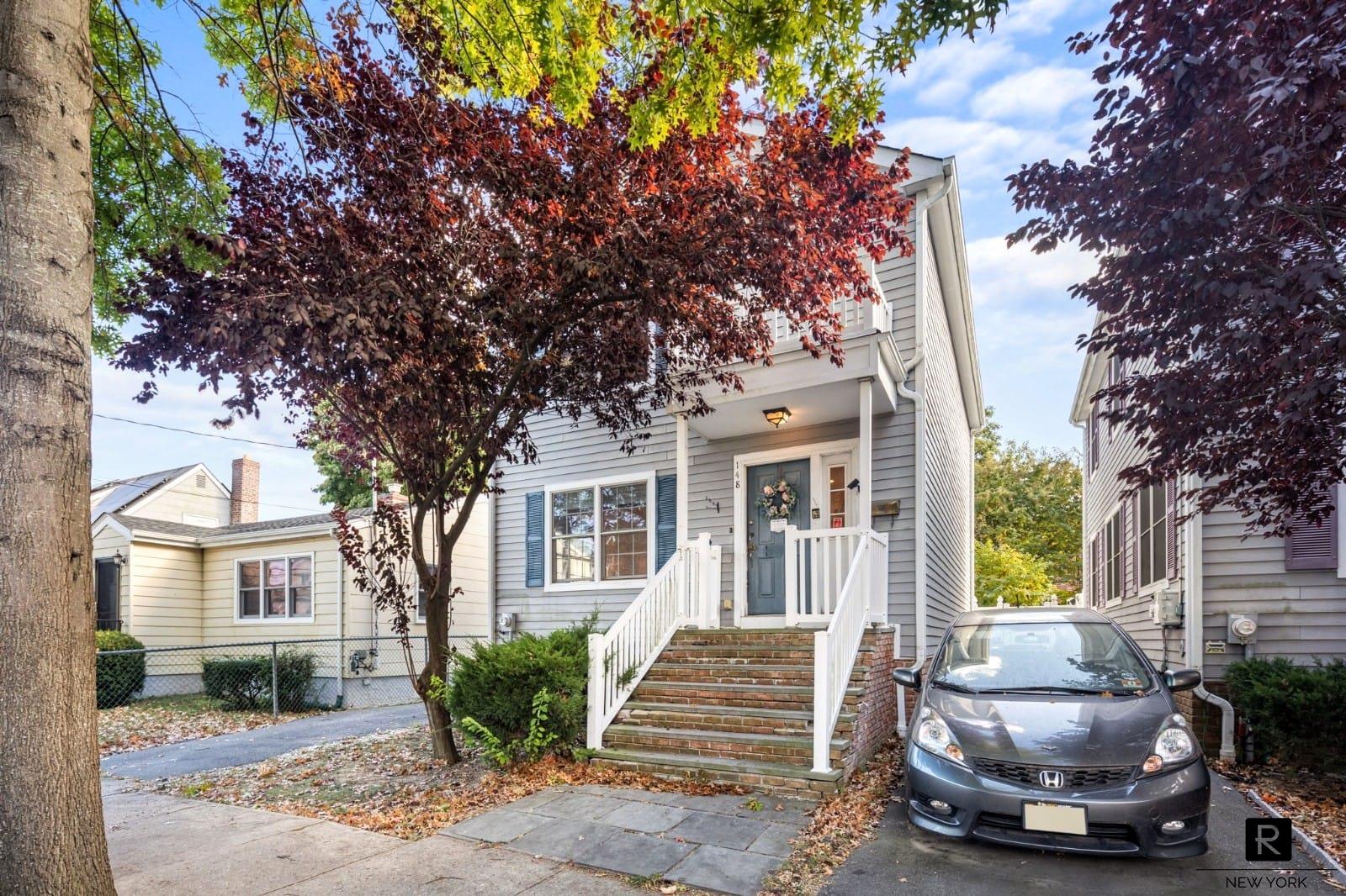 a view of a house with a tree in front