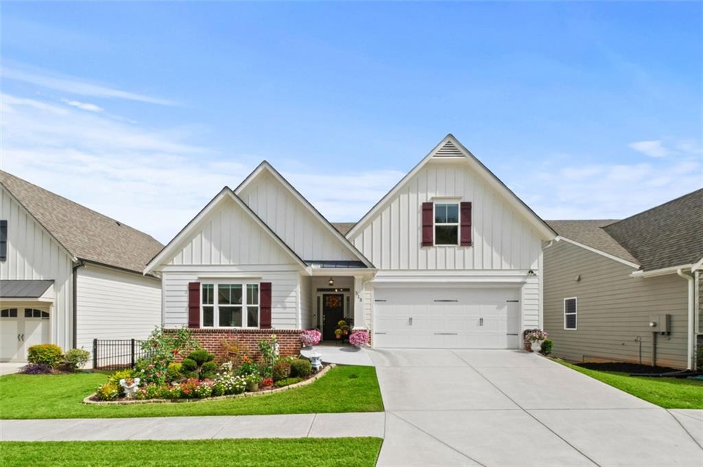 a front view of a house with a yard and garage