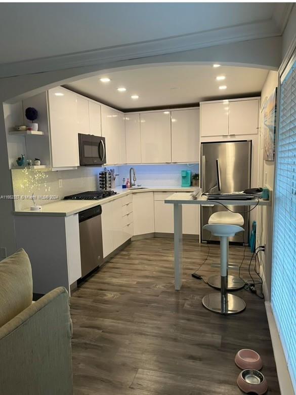 a kitchen with a sink cabinets and wooden floor