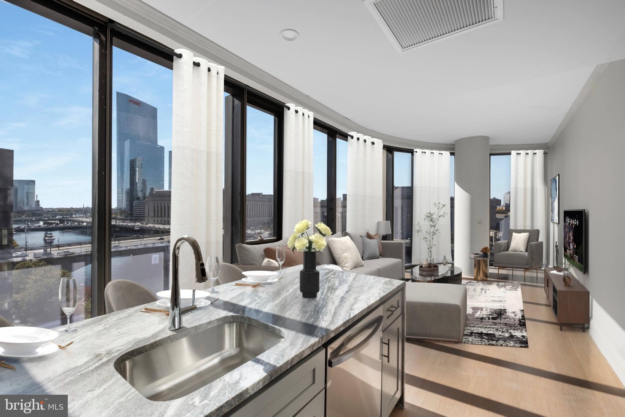 a kitchen with kitchen island granite countertop a sink and a view of living room