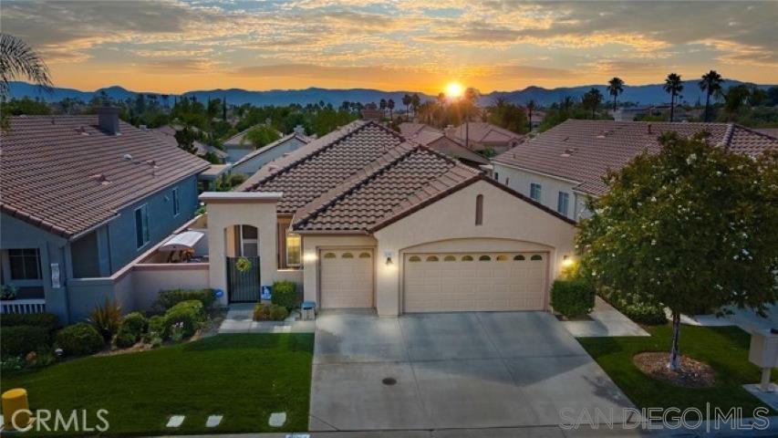 a aerial view of a house next to a yard