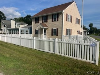 a view of a house with a yard and deck