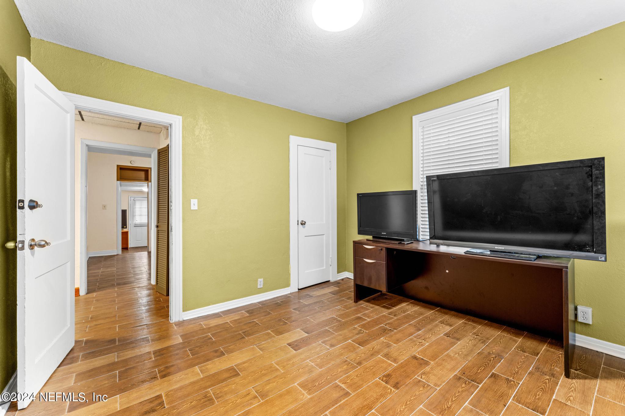 a living room with a flat screen tv and a stove