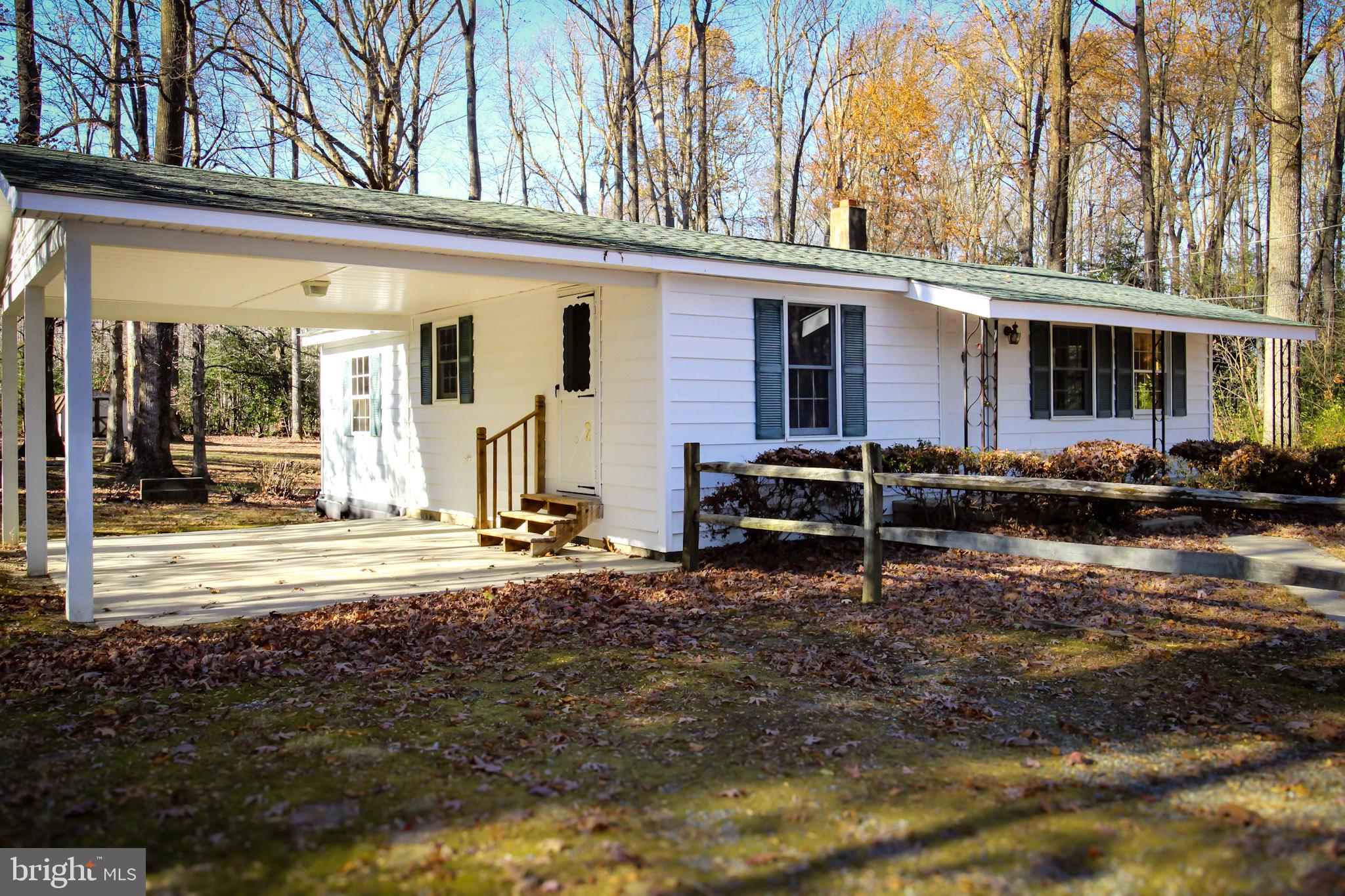 a view of a house with backyard porch and sitting area