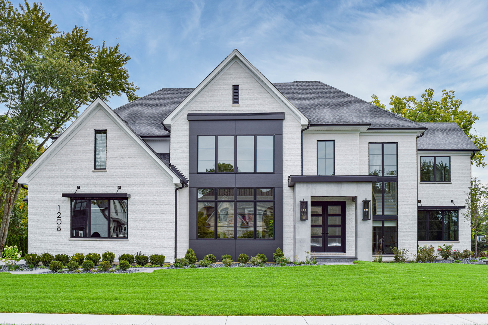 a front view of house with a garden