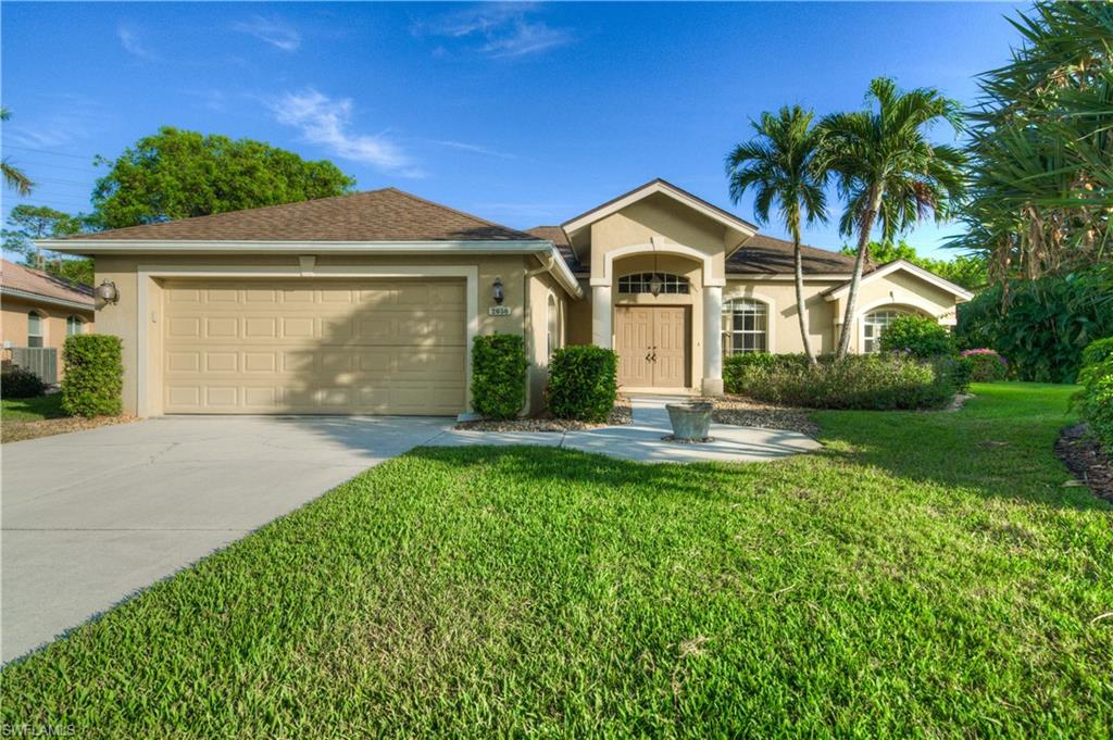 a front view of a house with a yard and garage