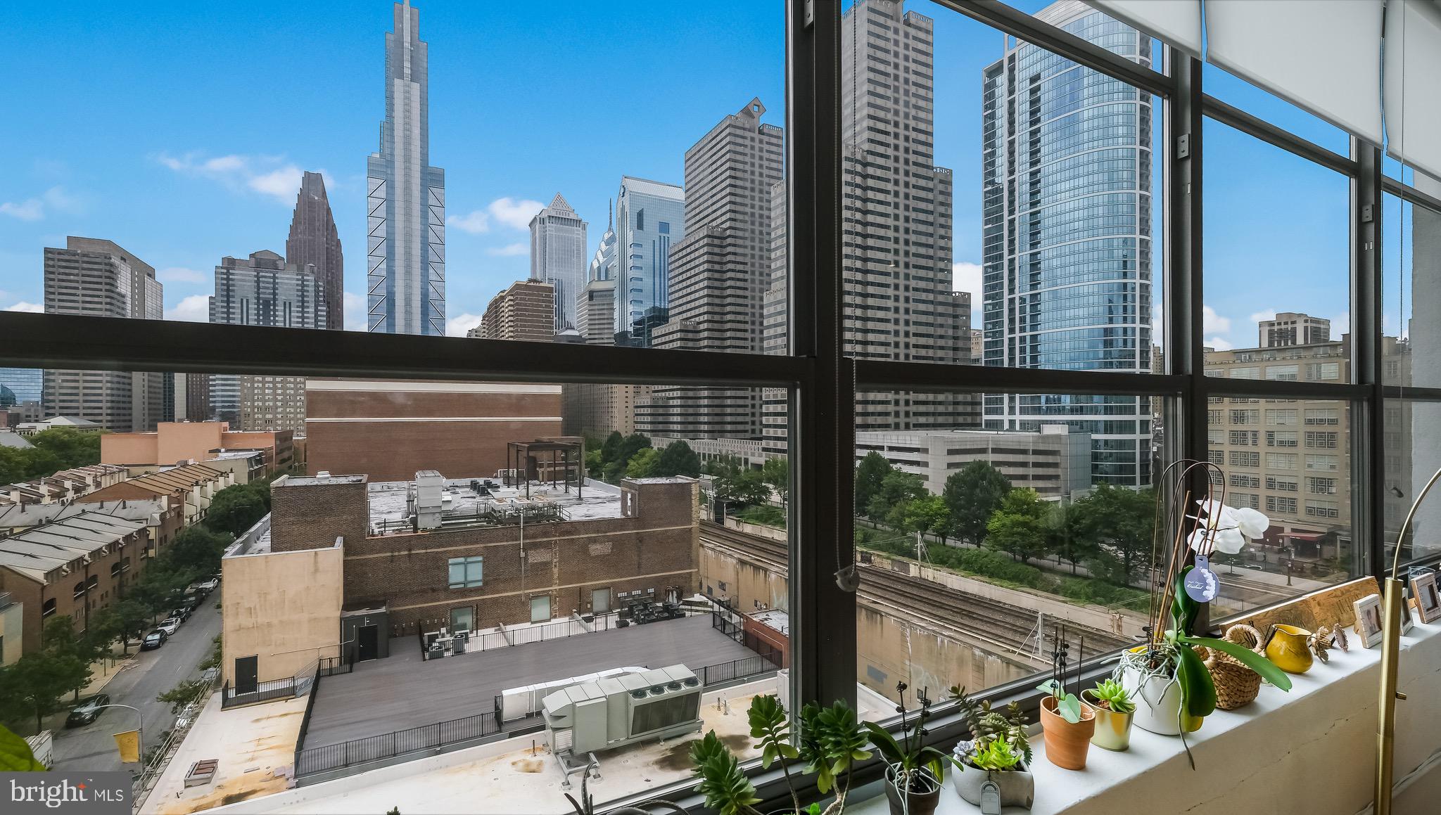 a city view from a balcony with chairs