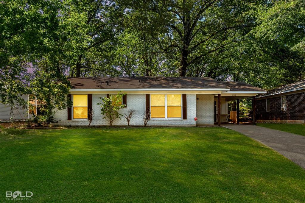 a view of a house with a backyard