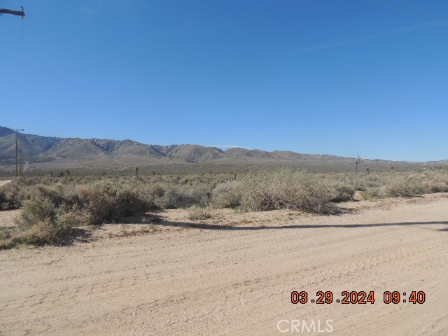 a view of a dry yard with mountain