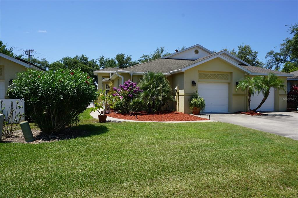 a front view of a house with a yard and a garage