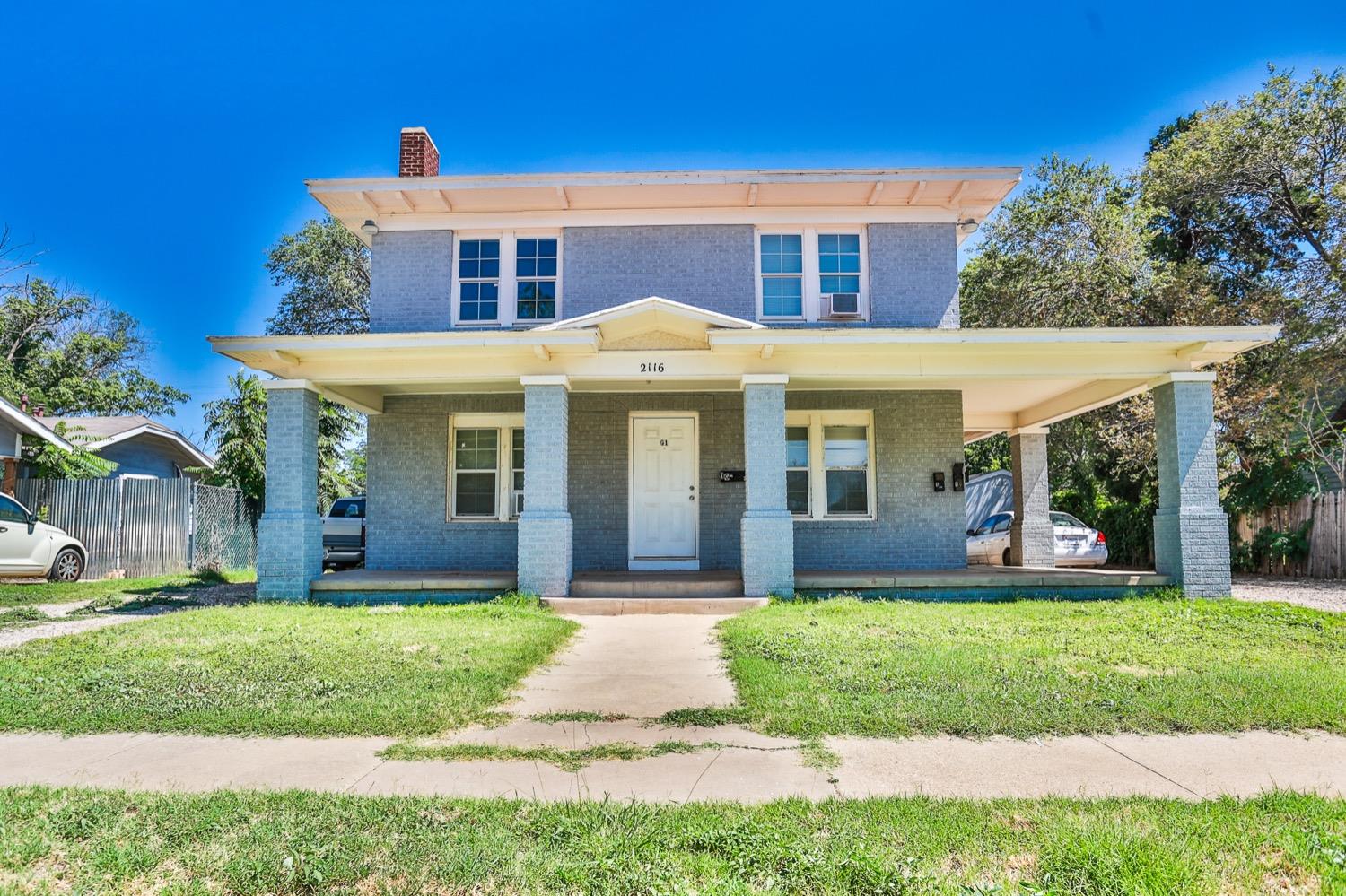 a front view of a house with a yard and porch