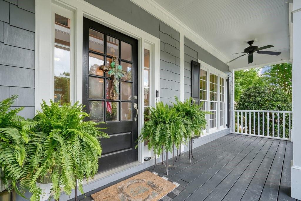 a porch with seating space and hardwood floor