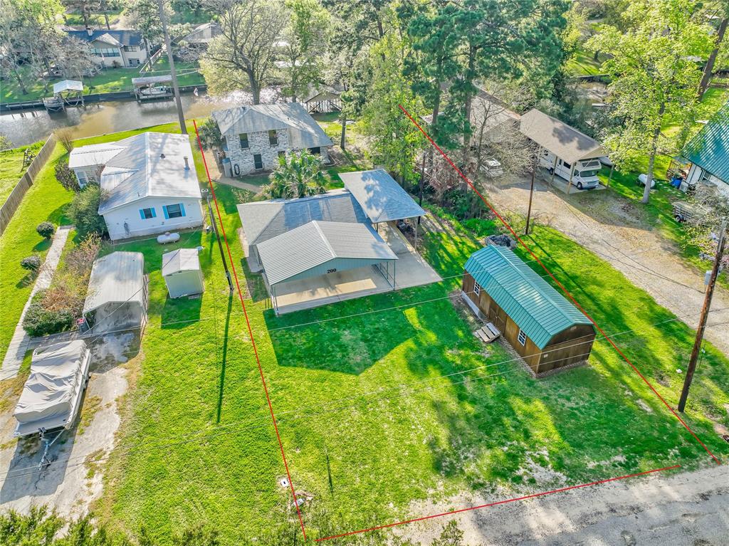 an aerial view of a house with a garden and lake view