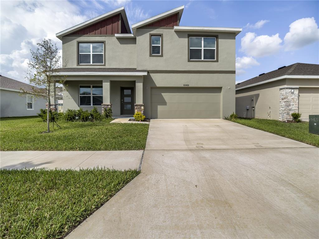 a front view of a house with a yard and garage