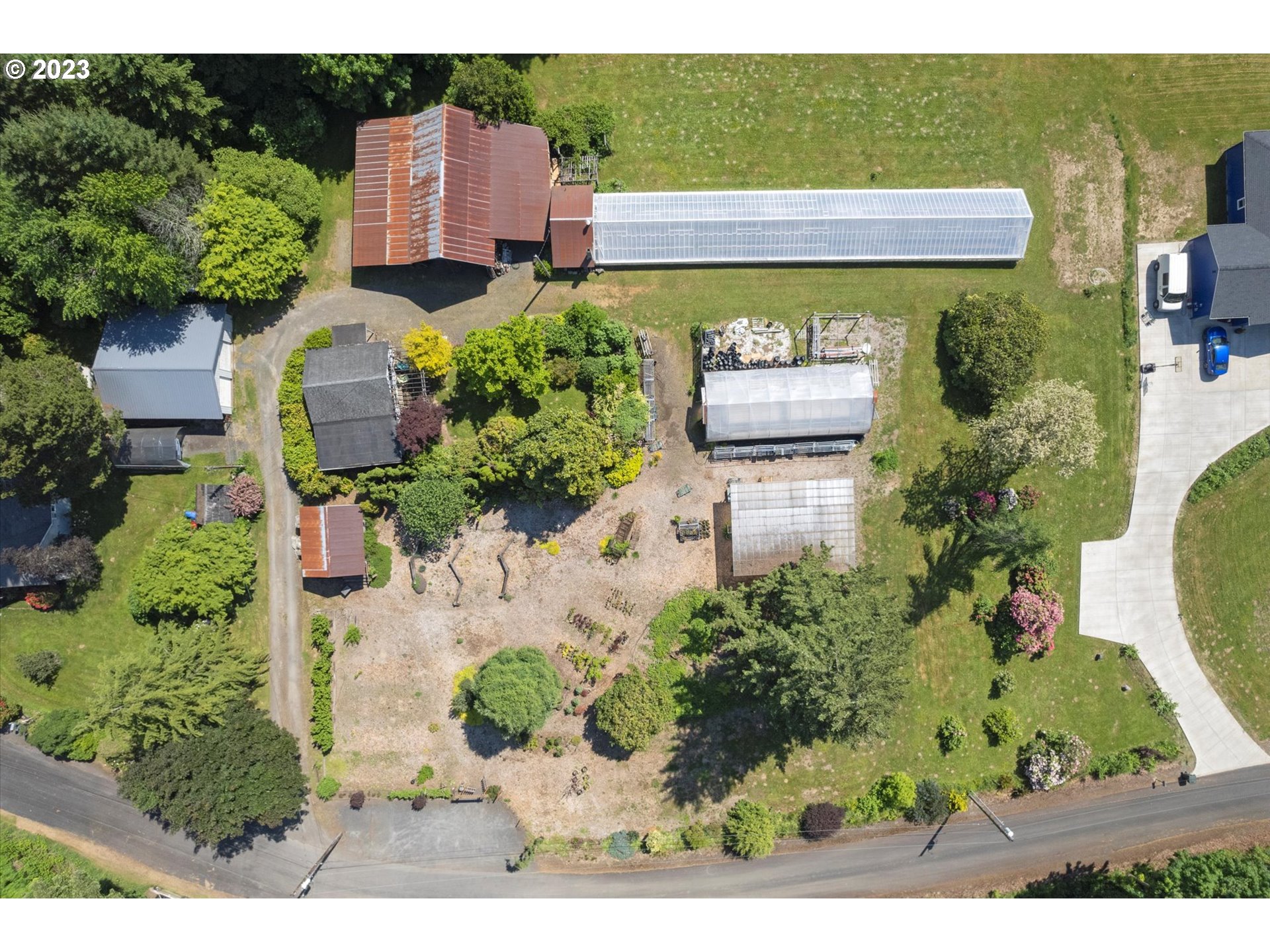 an aerial view of a house with a yard basket ball court and outdoor seating