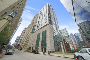 a view of a tall building next to a road