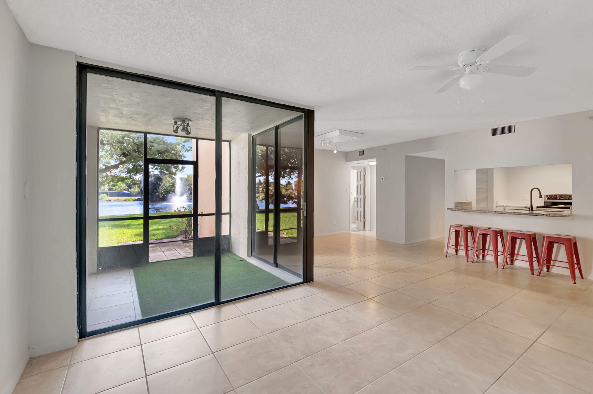 a view of a livingroom with a furniture and floor to ceiling window