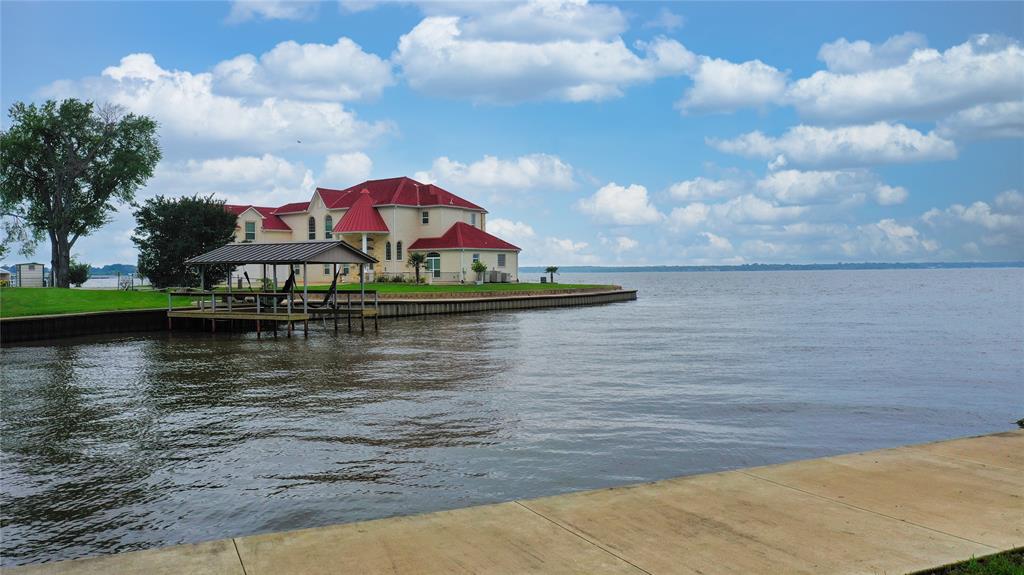 a view of a lake with houses in the background