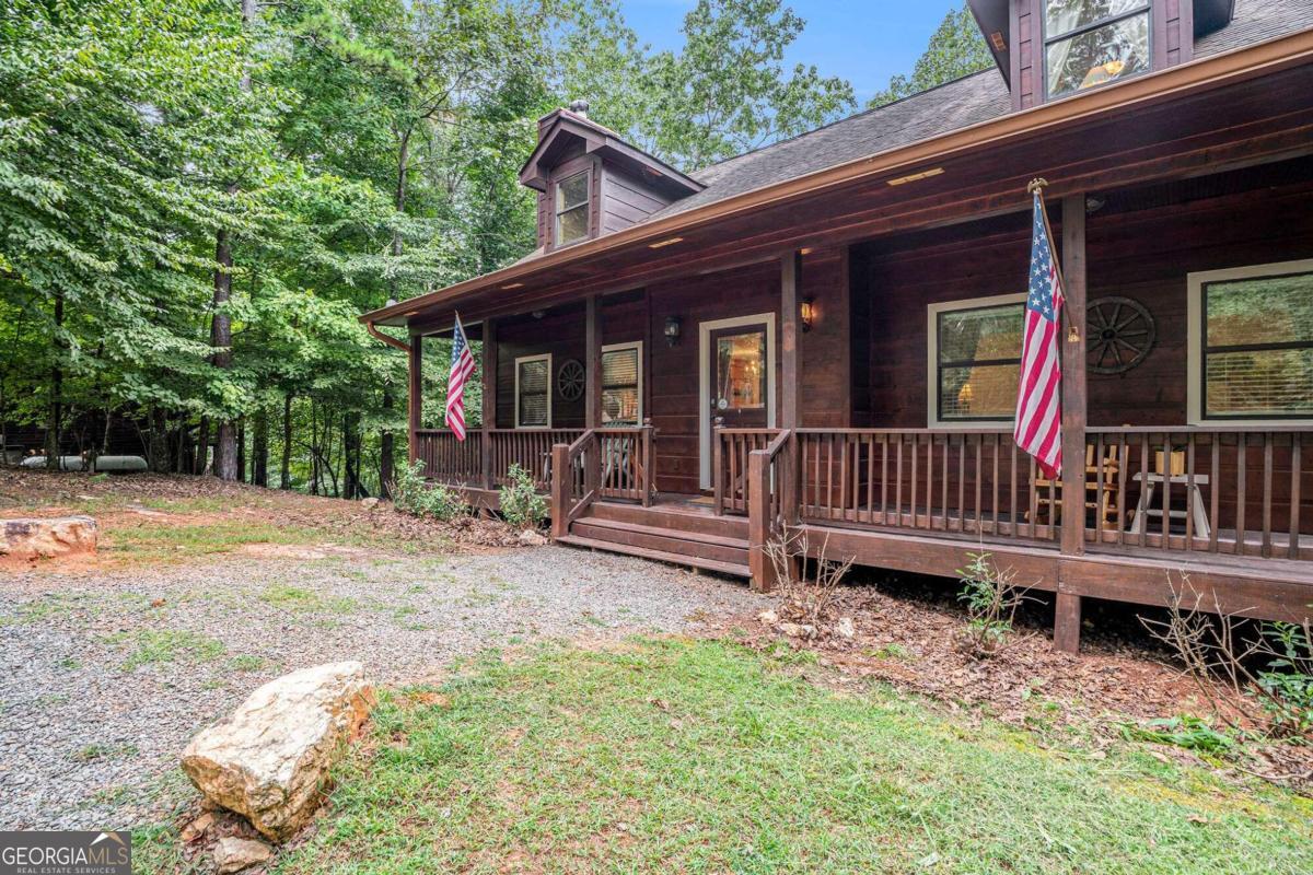 a backyard of a house with a deck and barbeque oven