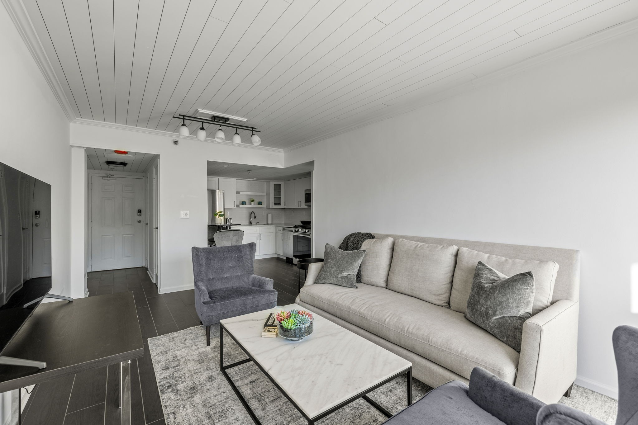 a living room with furniture and a flat screen tv